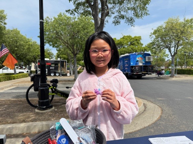 cute attendee - girl in pink sweater with prize STEM 2025