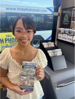 Francesca Aujero holding her schedule on a bus